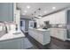 Modern kitchen featuring quartz countertops, a large island, and custom cabinetry for ample storage at 3845 Glen Ian Dr, Loganville, GA 30052