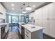 Bright, spacious kitchen features white cabinets, granite countertops, large island, and modern pendant lighting at 3845 Glen Ian Dr, Loganville, GA 30052