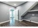 Laundry room boasts wood floors, gray walls, and convenient access to the outdoors through a white door at 3845 Glen Ian Dr, Loganville, GA 30052