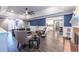 Open-concept living area with wood floors, fireplace, and seamless transition to breakfast nook and kitchen at 3845 Glen Ian Dr, Loganville, GA 30052