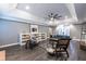 Bright living room with wood floors, built-in shelving, and a large ceiling fan at 3845 Glen Ian Dr, Loganville, GA 30052