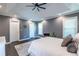 Main bedroom displays a tray ceiling, ceiling fan, carpet, and well-lit space from the windows at 3845 Glen Ian Dr, Loganville, GA 30052