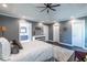 Main bedroom features tray ceiling, ensuite bathroom, decorative plants, and windows at 3845 Glen Ian Dr, Loganville, GA 30052