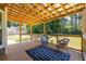 Outdoor porch with wooden roof, metal railing and wicker furniture at 3845 Glen Ian Dr, Loganville, GA 30052