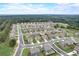 An aerial view captures a neighborhood with neatly arranged homes nestled amidst a verdant forest backdrop at 1173 Gaines St, Jonesboro, GA 30238