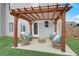 Backyard patio covered by a wooden pergola and wicker furniture at 1173 Gaines St, Jonesboro, GA 30238