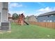 Backyard view featuring a playset, rear home elevation, and lawn at 1173 Gaines St, Jonesboro, GA 30238