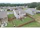 A fenced backyard featuring a pergola with outdoor seating and a playground set on green grass at 1173 Gaines St, Jonesboro, GA 30238