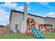 Backyard view featuring a playset, rear home elevation, and lawn at 1173 Gaines St, Jonesboro, GA 30238