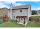 Back exterior view of a gray house with a pergola and play set in a fenced backyard with lush green grass at 1173 Gaines St, Jonesboro, GA 30238
