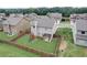 A fenced backyard offers a pergola and a playground, set on green grass among neighboring homes at 1173 Gaines St, Jonesboro, GA 30238