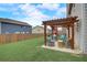 Cozy backyard patio with a pergola, outdoor seating, playset, and grassy lawn at 1173 Gaines St, Jonesboro, GA 30238