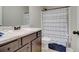 Bathroom with a sleek vanity, modern sink, and decorative shower curtain at 1173 Gaines St, Jonesboro, GA 30238