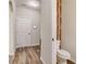 A well-lit half-bathroom showcasing wood-look flooring and a modern toilet at 1173 Gaines St, Jonesboro, GA 30238
