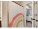 Bathroom door opens to bedroom suite with a rainbow shower curtain and white door at 1173 Gaines St, Jonesboro, GA 30238