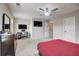 Spacious bedroom featuring a ceiling fan, TV, and ample natural light at 1173 Gaines St, Jonesboro, GA 30238