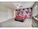 Inviting bedroom with a striking accent wall, ceiling fan, and cozy carpet at 1173 Gaines St, Jonesboro, GA 30238