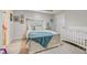 This is a well lit carpeted bedroom with a white crib, dresser and decor on the walls at 1173 Gaines St, Jonesboro, GA 30238