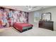Bright bedroom with a modern ceiling fan, vibrant wall art, and a cozy feel at 1173 Gaines St, Jonesboro, GA 30238