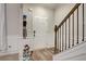 Bright entryway featuring hardwood floors, white wainscoting and dark wood stair railings at 1173 Gaines St, Jonesboro, GA 30238