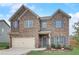 Two-story home with brick and stone accents, a two-car garage, and blue shutters at 1173 Gaines St, Jonesboro, GA 30238