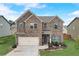 Charming two-story brick home with a well-manicured lawn and attached two-car garage at 1173 Gaines St, Jonesboro, GA 30238