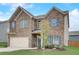 Two-story brick home with an attached two-car garage with a manicured lawn at 1173 Gaines St, Jonesboro, GA 30238