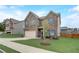 A two-story brick home with an attached garage is complemented by a green lawn and sidewalk at 1173 Gaines St, Jonesboro, GA 30238
