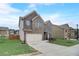Two-story brick home with an attached two-car garage and lovely lawn at 1173 Gaines St, Jonesboro, GA 30238