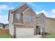 Lovely two-story brick home with an attached two-car garage and manicured lawn at 1173 Gaines St, Jonesboro, GA 30238