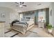 Comfortable main bedroom featuring a tufted headboard, accent wall, bench, and ceiling fan at 1173 Gaines St, Jonesboro, GA 30238