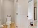 Bathroom featuring a toilet, tile floor and door opening to the shower and tub area at 1173 Gaines St, Jonesboro, GA 30238