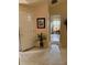 Inviting entryway with neutral tones, featuring a decorative plant and framed artwork at 2863 Hillvale Cove Dr, Lithonia, GA 30058