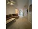 Comfortable living room featuring a sectional sofa, neutral carpeting and lots of light at 2863 Hillvale Cove Dr, Lithonia, GA 30058