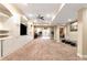 Finished basement with carpet, built-in shelving, and a view of the kitchen at 3332 Heathchase Ln, Suwanee, GA 30024