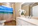 Bathroom with white vanity, large mirror, tiled floor, and shower with ocean-themed curtain at 3332 Heathchase Ln, Suwanee, GA 30024