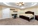 Bedroom with a desk, shelving, a ceiling fan, and a comfortable bed at 3332 Heathchase Ln, Suwanee, GA 30024