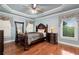 Comfortable bedroom with hardwood floors, a ceiling fan, and large window at 3332 Heathchase Ln, Suwanee, GA 30024