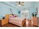 Charming blue bedroom with a tray ceiling, hardwood floors, and a window at 3332 Heathchase Ln, Suwanee, GA 30024