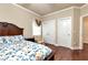 Comfortable bedroom with a patterned bedspread, hardwood floor, and natural light at 3332 Heathchase Ln, Suwanee, GA 30024