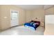 Bedroom with neutral walls and tile flooring featuring a queen bed and access to the outdoors at 3332 Heathchase Ln, Suwanee, GA 30024