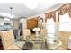 Bright dining area features a glass table with seating for four near updated kitchen at 3332 Heathchase Ln, Suwanee, GA 30024