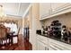 Elegant dining area with a granite-topped bar area, wine racks, and fine furnishings at 3332 Heathchase Ln, Suwanee, GA 30024