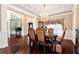 Formal dining room with a chandelier, decorative pillars, piano and elegant decor at 3332 Heathchase Ln, Suwanee, GA 30024