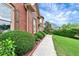 Charming walkway leading to a well-maintained brick home with lush landscaping and mature shrubs at 3332 Heathchase Ln, Suwanee, GA 30024