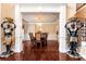 Elegant foyer featuring statues, pillars, an ornate chandelier, and an open dining area at 3332 Heathchase Ln, Suwanee, GA 30024