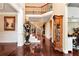 Grand foyer showcasing a staircase, decorative statues, and an open floor plan at 3332 Heathchase Ln, Suwanee, GA 30024