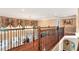 Hallway with hardwood floors, iron railing, chandelier, and stylish curtains above large windows at 3332 Heathchase Ln, Suwanee, GA 30024