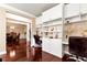 Bright home office features custom built-ins, desk space, and dark, glossy hardwood floors at 3332 Heathchase Ln, Suwanee, GA 30024
