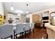 Modern kitchen with white cabinets, stainless appliances, granite counters, and seating at the island at 3332 Heathchase Ln, Suwanee, GA 30024